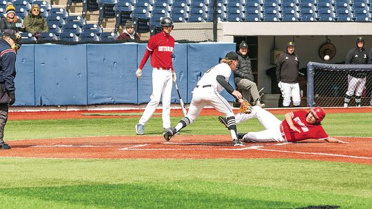 Glen Lake pitcher Peter Gelsinger runs to home plate just in time to tag a Suttons Bay runner in a close call. Photo courtesy of Nicole Marton