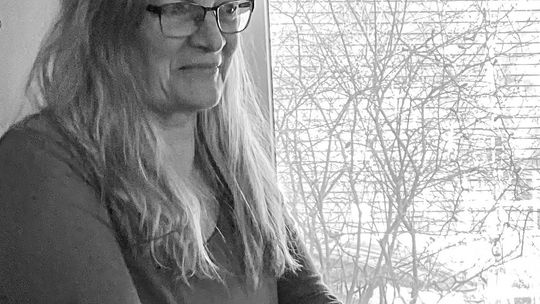 Northport resident Laura Kalchik is pictured writing her final “From the Heart” editorial for the 25th anniversary/farewell edition of her publication “Families First Monthly.” Courtesy photo