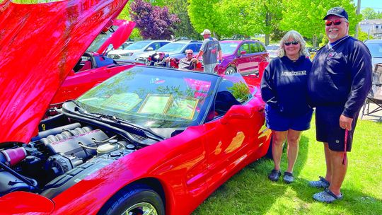 Brian and Theresa Cole of Interlochen, pictured here, brought their torch red 1998 Chevrolet Corvette to the 2023 show, placing in the windshield a framed picture of Brian’s brother, Scott, who was killed in 2001 while serving in the U.S. Army. In honor of Memorial Day, Brian said displayi...