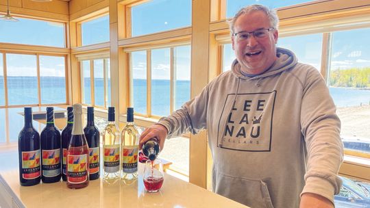 Leelanau Cellars President Bob Jacobson pours cheers to 50 years of business on the Leelanau Peninsula at their Omena tasting room. Enterprise photo by Brian Freiberger