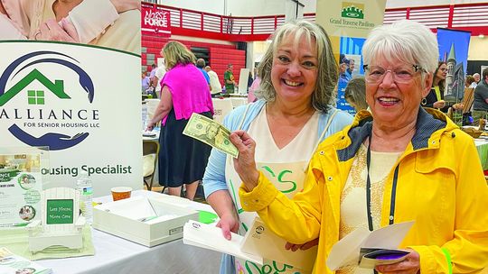 Leelanau resident Joy Anderson (right) won $20 at Connie Hintsala's (left) table on Tuesday afternoon at the senior expo
