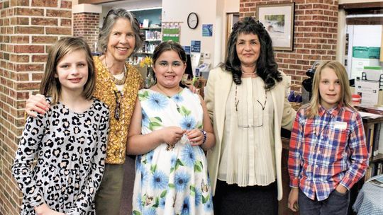 Northport Public School students (from left to right) Charlotte Murphy, Arya Cavendish, and Pierson Humphrey are pictured with Leelanau Township Library Poetry Month Chair Alison Arthur and library assistant Marie Gaspari during open mic night last year. Courtesy photo