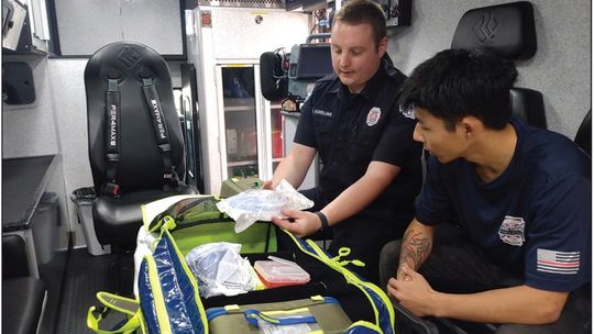 Vinni Ciricola, right, a student intern from Eastern Michigan University, learns medical response skills from Leland Township Fire &amp; Rescue Lieutenant Chris Schelling at the Lake Leelanau station. Ciricola is interning with the department over the summer to fulfill course requirements...