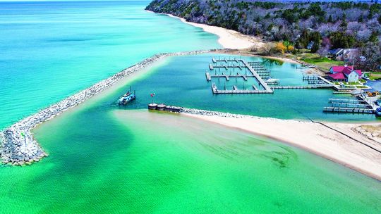 Leland harbormaster Jeremy Anderson and Jim Munoz began dredging the mouth of the Leland River this week. This is a view from above. Courtesy photo
