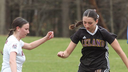 Leland sophomore Lillian Connor battles for possession against Suttons Bay sophomore Megan Lint during a conference game last week