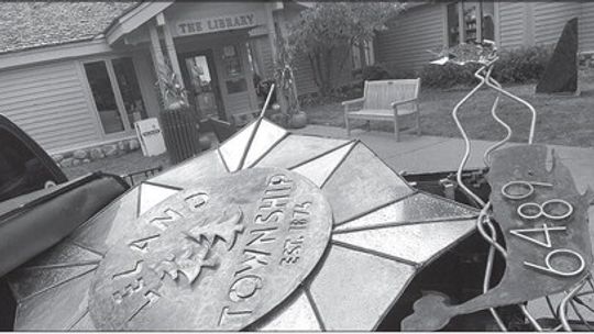 Leland Township trustee Mariann Kirch created a sign for the municipality that would likely be placed in the future outside of the township’s building off Main Street. The sign is 45 inches across referencing the 45th Parallel, the two trees represent Leland and Lake Leelanau, and the whal...