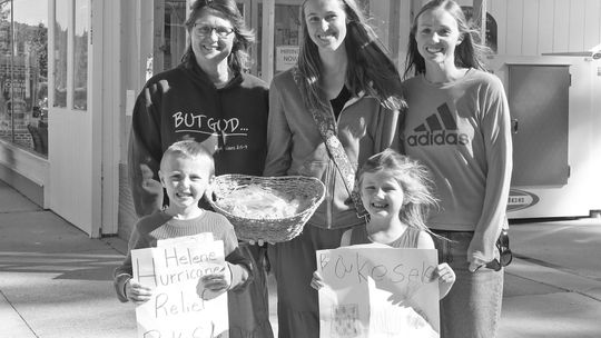 Barb Plamondon and her daughters Melissa Hapala and Casey Cholowinski, from left, held a bake sale Friday with grandchildren Aiden and Aurora. Enterprise photo by Brian Freiberger