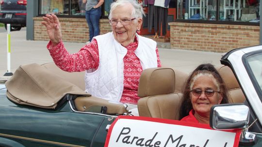 Longtime Suttons Bay teacher Joyce Nash rode through the streets in fashion as the Homecoming Grand Marshal along with Ulain Weber in the front. Enterprise photo by Brian Freiberger