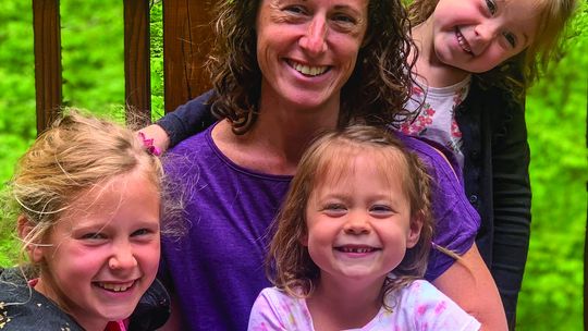 A day at the beach with her children inspired Brittany Darga to write a book about Petoskey stones. She is pictured here with daughters Abigail, 8, and twins, Morgan and Anna, 5. Courtesy photo