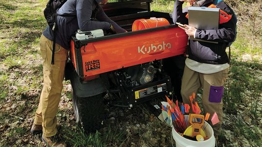 Conservancy land stewards Chad Jordan, left, and Emily Douglas prepare for a day in the field collecting data within deer enclosures at Palmer Woods Forest Preserve. Courtesy photo