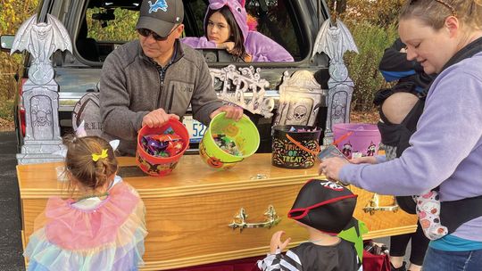 Nick Martinson of Martinson Funeral Home went all out for St. Mary School’s trunk-or-treat, bringing candy and a casket. Enterprise photo by Mike Anderson