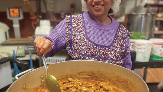 Regani Punheni, otherwise known as 'Rosie', cooking chicken curry at NJ's Grocery in Lake Leelanau. Enterprise photo by Brian Freiberger