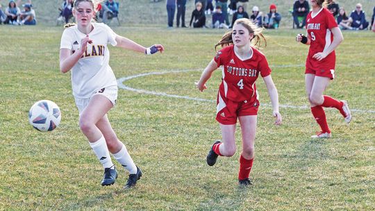 Leland senior Olive Ryder and Suttons Bay senior Lauren Lint compete during the 2023 season. Enterprise photo by Brian Freiberger