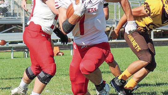 Lake Leelanau St. Mary senior Luke Bramer jukes a defender then races forward for positive yards against Pellston during a 42-16 win Saturday.