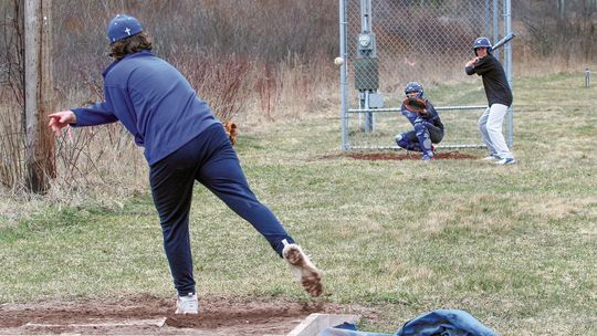 Suttons Bay’s Anthony Oskaboose batting (right) and catcher Gavin Schichtel (left) practice during spring ball Monday. Enterprise photo by Brian Freiberger