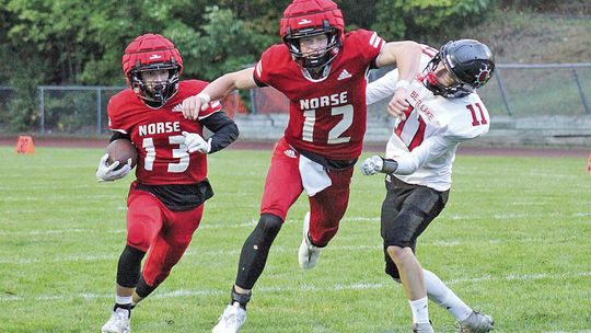 Suttons Bay senior quarterback Grayson Opie blocks for running back Jackson Loucks during a 33-16 win over Bear Lake on Friday. Photo courtesy of Cynthia Opie