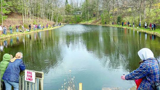 People line around the Mill Pond to try their hand at catching rainbow trout stocked by the Northport Sportman’s Club.