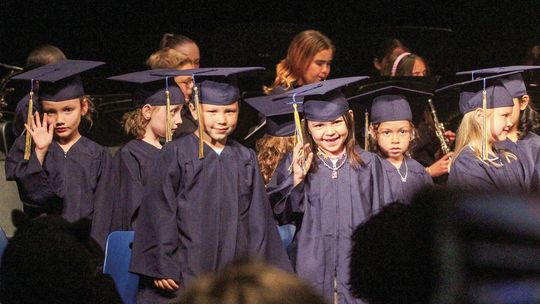 Northport kindergartners celebrate graduation by waving to families Friday