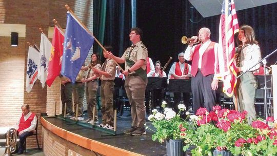 The Suttons Bay Scouts display the flags of the five branches of the U.S. Armed Forces at Northport’s Memorial Day service, which was relocated to the Northport Public Schools auditorium due to rains Monday. Enterprise photo by Zachary Marano