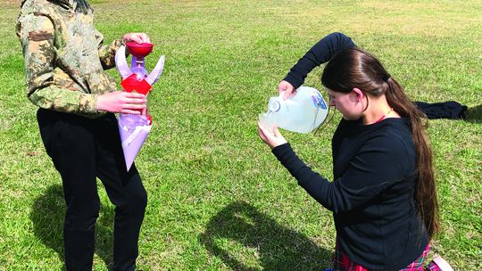 Northport Public School 8th grader Jack Scripps (left) and 7th grader Lilly Gmoser-Duhamel (right) carefully measure the water to add to their rocket on rocket launch day as part of the NASA Artemis Challenge. Photo courtesy of Karen Trolenberg