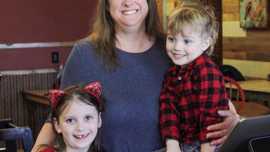 Cindy Henderson stands proudly with her grandchildren Lylah and Ollie after announcing the opening of Ollie R’s, a new burger joint in the same building that holds Lylah’s cafe. Enterprise photo by Brian Freiberger
