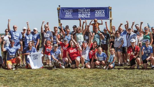 Nearly all “Bolters” of The Bolt 5 in Northport pose for a group photo at the end of the race on Saturday. Courtesy photos