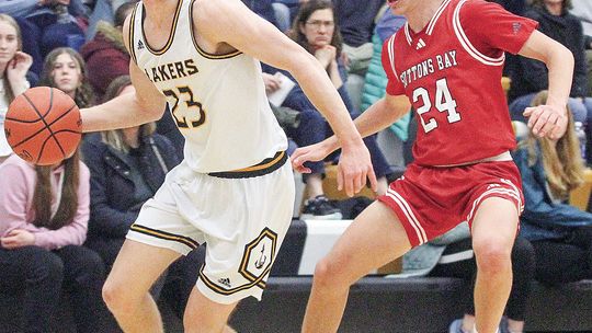 Suttons Bay senior Finn Mankowski (right) guards Glen Lake senior Dylan Cundiff during a district semifinal game Wednesday, February 28.