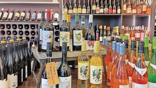 While wine and other alcohol beverage prices range anywhere from $12 to several hundred dollars at Peninsula Provisions, people can find assorted drinks for about $20 and under placed on the lengthy table in the back room of the store.