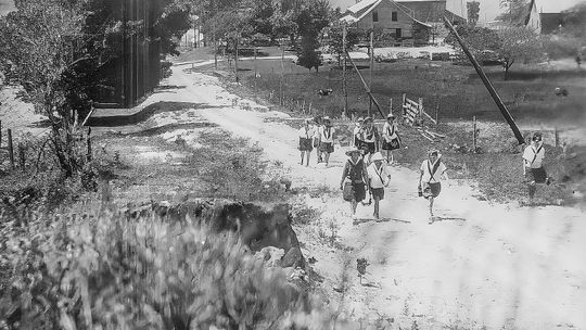 Nine girls from Camp Oshibwa travel up Horn Road in the heat as part of a excursion. Photo courtesy of the Leelanau Historical Museum