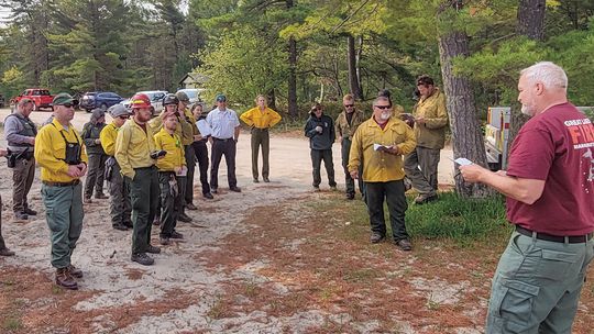 Wildland firefighters meet for a briefing during the 2023 Good Harbor Bay prescribed fire. Photo courtesy of the National Park Service.