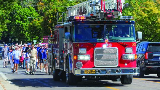 Leland bridge walkers follow a Leland Township fire truck during the LAbor Day celebrations that was followed by refreshments at the Old Art Building. Enterprise photo by Brian Freiberger