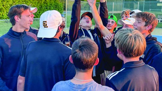 Glen Lake senior Ben Selby hoist the regional championship trophy after the Lakers came from behind to defeat TC St. Francis. The Lakers head to Midland for the state finals meet Monday and Tuesday. Courtesy photo