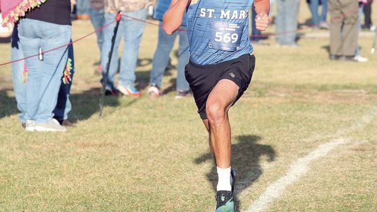 Lake Leelanau St. Mary junior Oliver Mitchell sprints to the finish line at regionals Saturday. Enterprise photo by Brian Freiberger