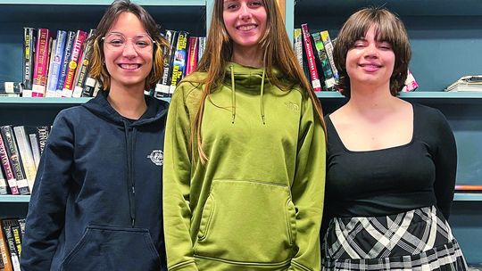 Suttons Bay High School students (from left to right) Reegan Craker, Isabel Schmidt, and Minnie Bardenhagen are pictured at school on Monday. Schmidt and Bardenhagen are finalists in this year’s Young Playwright Festival at the City Opera House, and Craker is a semi-finalist. The three stu...