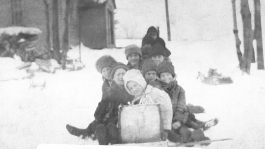Laura Basch: “One of the things we had—I don’t know who furnished the toboggan, but somebody furnished a toboggan; and I have a picture of it, and I’ll find it, too, for you. It’s a picture of a whole bunch of us kids on the toboggan and that little hill as you go down to the lake. We coul...