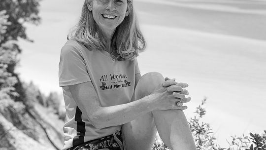 Kelly Slater of Suttons Bay, vice president of the Traverse City Track Club, poses in front of the waters of Lake Michigan. Courtesy photo