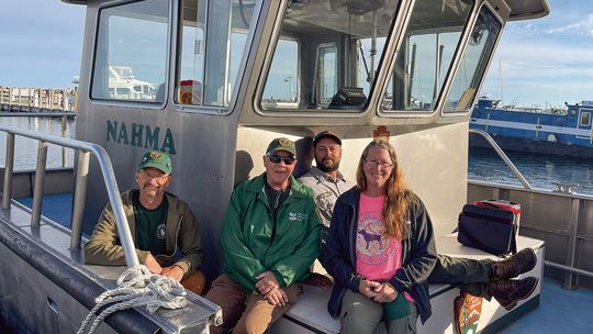 Sleeping Bear Dunes National Lakeshore volunteers (from left to right) John England, Patty Kelly, boat captain Adam Reitz, and Mandy England are pictured Wednesday morning while loading up for a two week trip to South Manitou Island. Kelly, 72, has been volunteering with the National Park...
