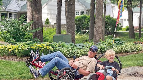 John Zavalkink of Northport rides a recumbent bike alongside his grandson. Zalvakink and Dan Zimmerman of Spoke Fighting Strokes will be hosting a recumbent trike event on the Leelanau Trail on August 15. Courtesy photo
