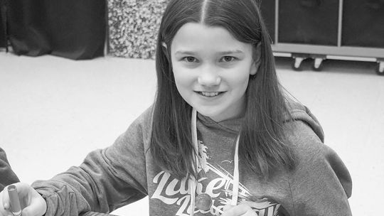 In celebration of community, Lilyana Graham, grade 5, decorates placemats for the spaghetti dinners to support Leelanau Christian Neighbors. Courtesy photos