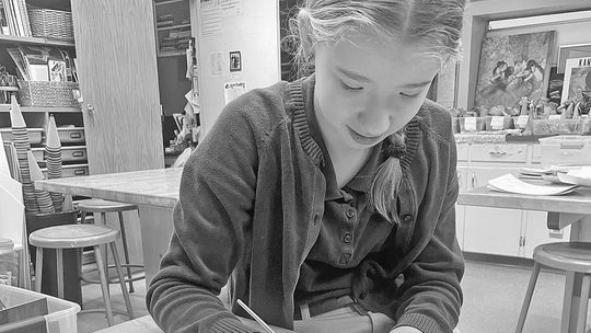 St. Mary School students created and mailed out Christmas cards to special friends including elderly community members, donors and local priests. Here, seventh grader Marie Hobbins paints Christmas cards for St. Mary School special friends. Courtesy photo