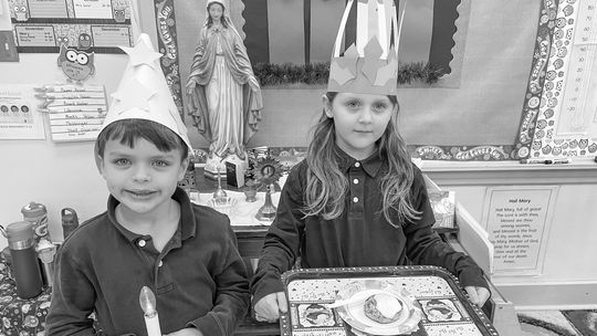 St. Mary second grade students experienced the Feast Day of St. Lucy with a traditional Swedish St. Lucia celebration. They proclaimed “St. Lucia invites you to breakfast” as they dropped off a meal to teachers and staff. Joe Mullane and Amelia Gawrysiak prepare to deliver breakfast. Court...