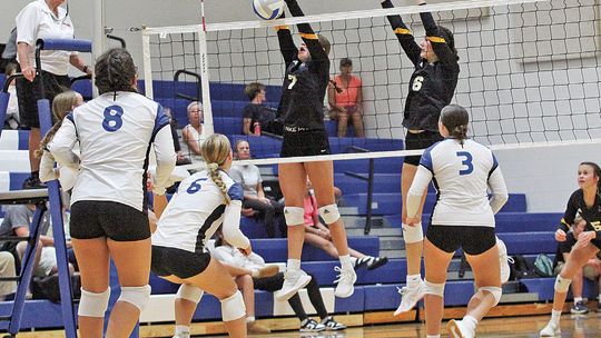 Glen Lake defender Lydia Brammer blocks a Lake Leelanau St. Mary kill from senior Cathryn Mikowski during a four set win for the Eagles last week. Enterprise photo by Brian Freiberger
