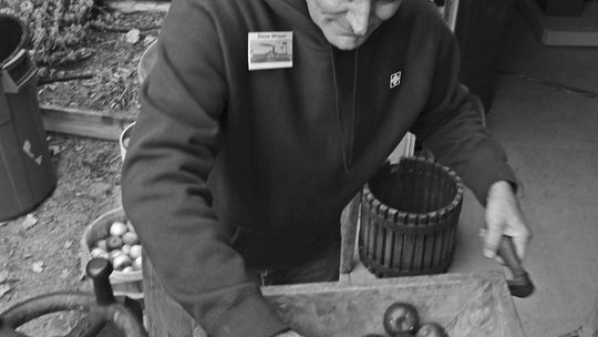 Steve Wilson helps demonstrate how to make apple cider during Heritage Days at the Empire Area Museum Saturday. Enterprise photo by Brian Freiberger