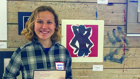 Leland freshman Natalie Burpee holds an issue of EXPOSURES 2024 during a student art show at the Old Art Building in Leland. Courtesy photo