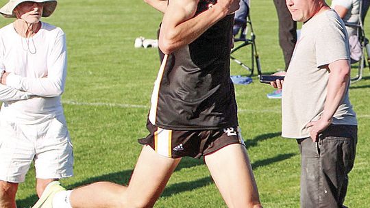 Glen Lake junior Colebrook Sutherland broke the school record for the two-mile on Monday with a time of 9:50.9. He beat the record set by Justin Kibbey in 1999 by nine seconds. Sutherland crosses the finish line as Laker long distance coach Jim Harrelsson (right) hits his timer. Photo cour...