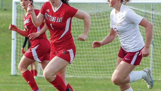 Suttons Bay sophomore defender Clarice Bardenhagen dribbles past a Charlevoix defender on Monday. Enterprise photo by Brian Freiberger