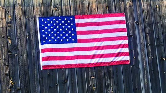 The flag’s 13 red and white stripes represent the 13 original colonies