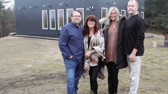 Three Trees Vineyard in Suttons Bay announced it will be aiming to open by summertime 2024. Phil and Lyle Cifuentes (left), and Scott and Laurie Muschong celebrate in the rain earlier this week. Enterprise photo by Brian Freiberger
