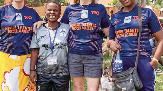 Courtesy photo Mary Taylor (left) and Judy Yoder (right) stand with women soccer players in Uganda a few year ago. A nonprofi t soccer program created by Leland seventh graders in 2016 has grown from 20 to 500, but recent developments have resulted in a fundraising effort to purchase the s...