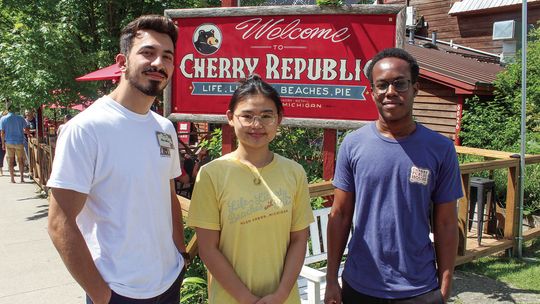 Several J1 visa and migrant workers help to make Cherry Republic function throughout summer and fall. From left to right: Mustafa Yesilay (Turkey), Freda Fan (China), and Kafhief Barnswell (Jamaica). Enterprise photo by Brian Freiberger